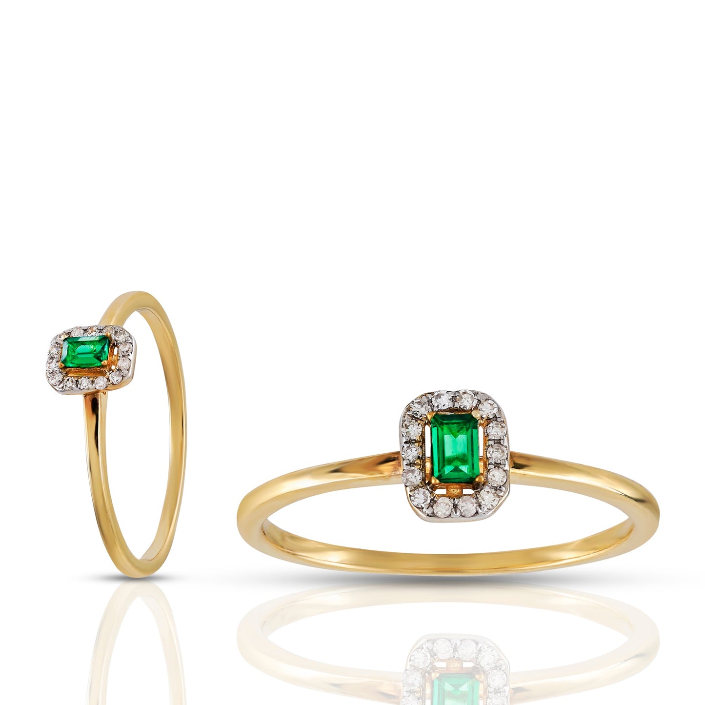 Gold ring with emerald and diamond accents on a white background