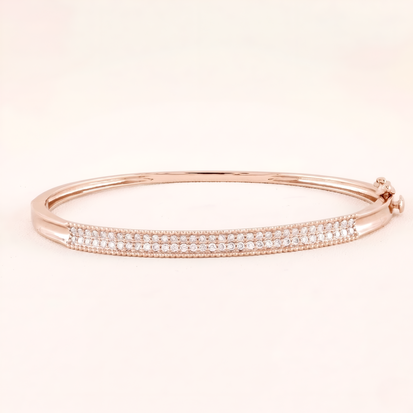Rose gold bracelet with small diamonds on a light pink background