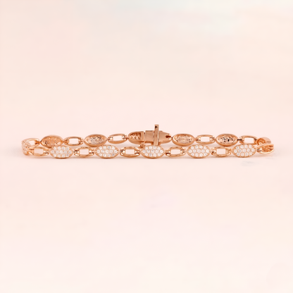 Rose gold bracelet with diamond accents on a light pink background