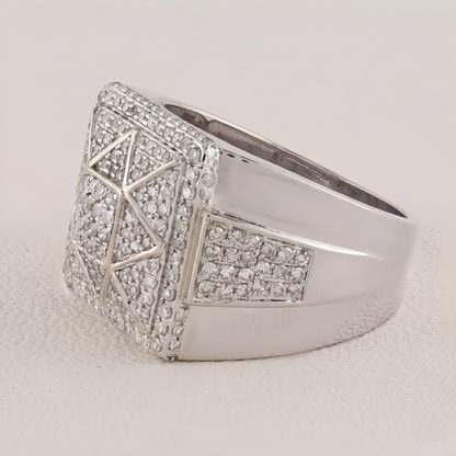 Silver ring with geometric design and embedded stones on a light background