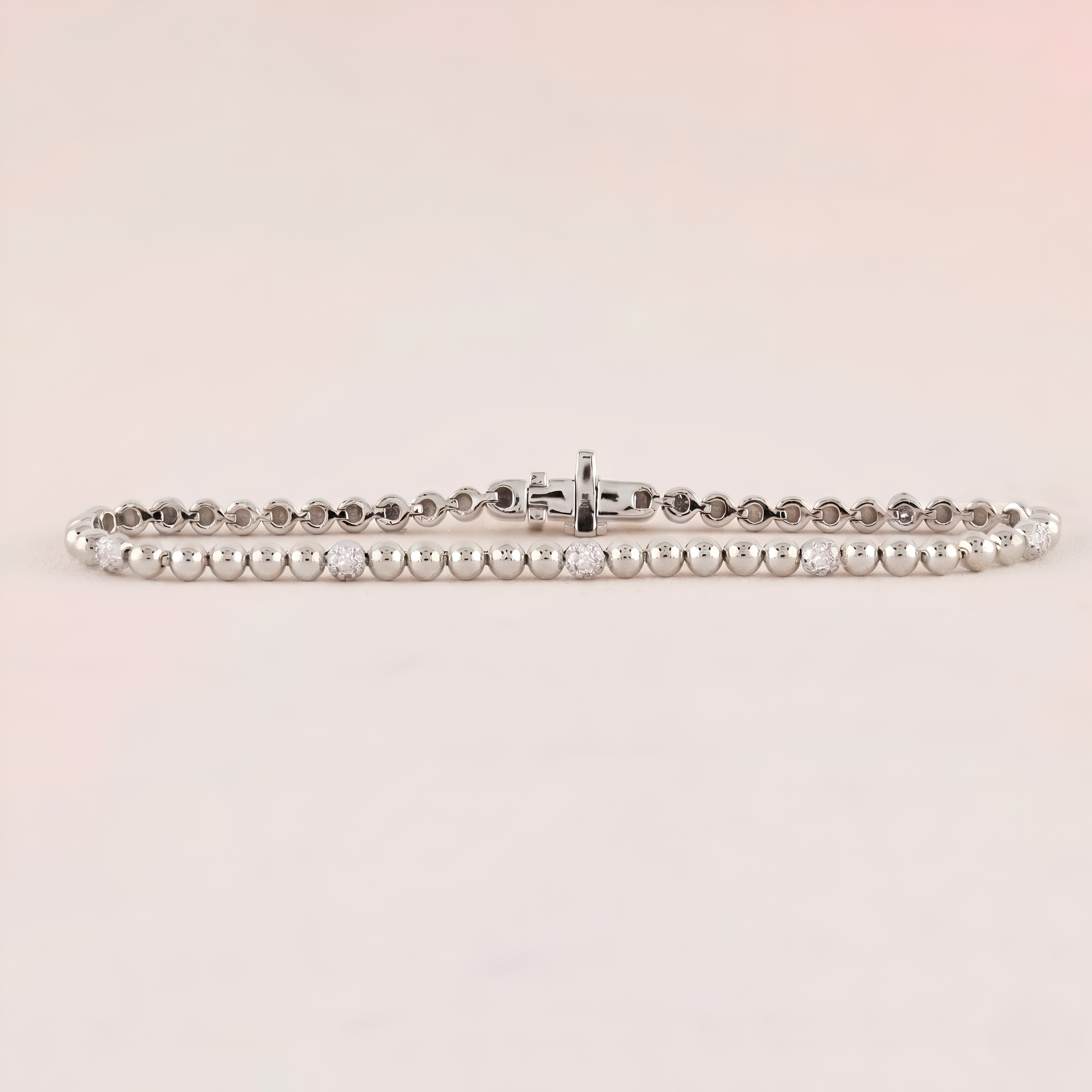 Silver bracelet on a light pink background
