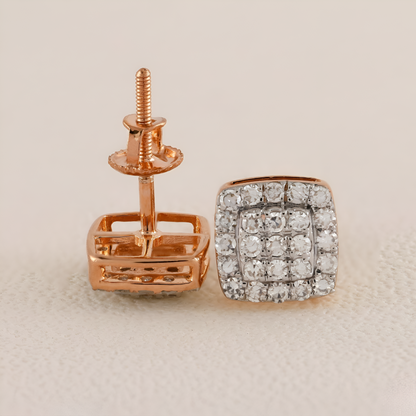 Rose gold earring with diamond accents on a beige background