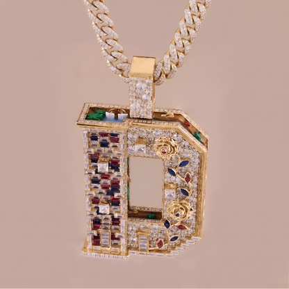 Gold pendant with gemstones on a beige background