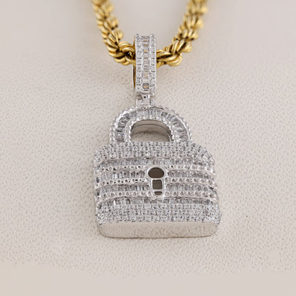Diamond-encrusted lock-shaped pendant on a gold chain against a beige background