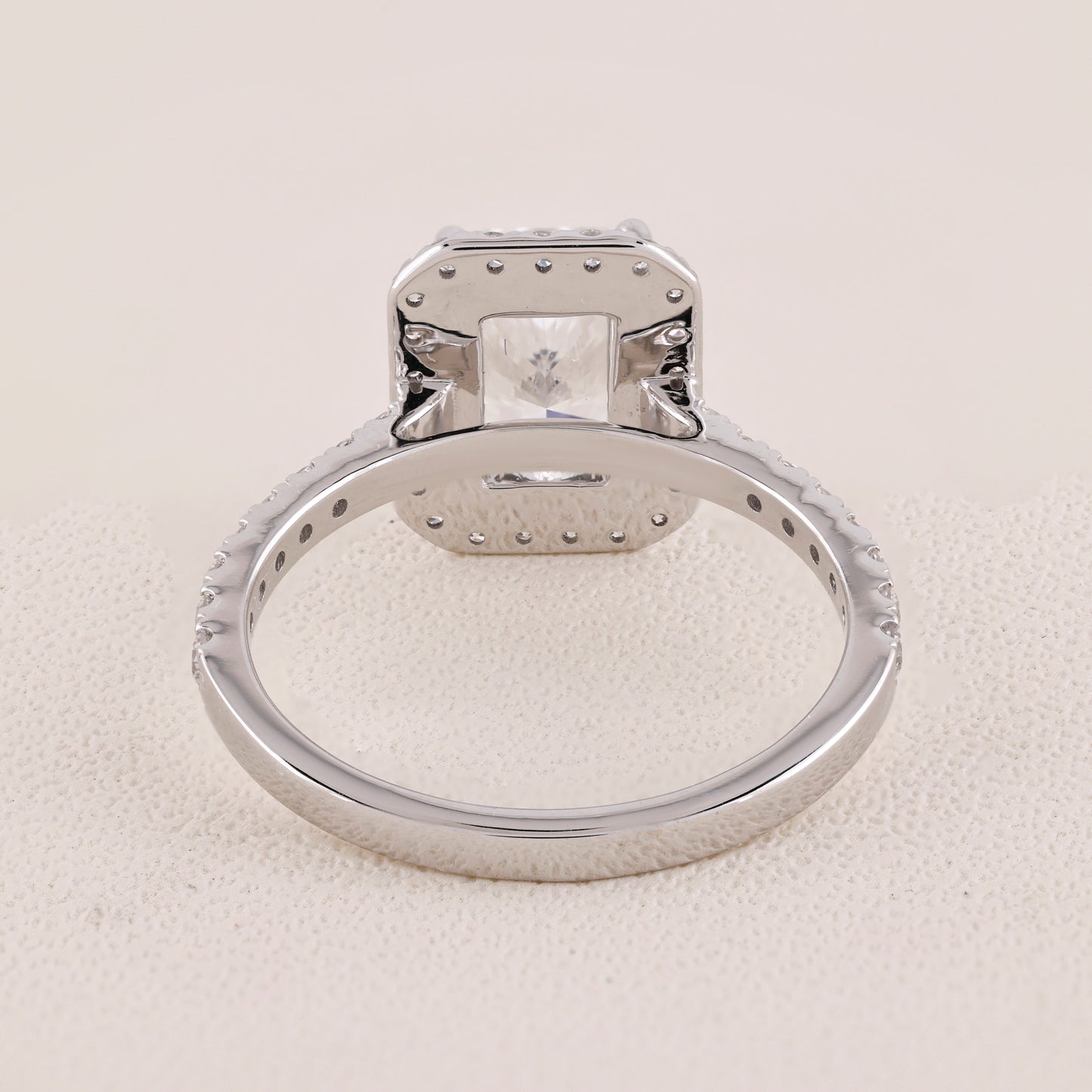 Silver ring with a diamond on a light gray background