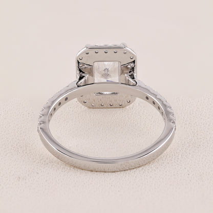 Silver ring with a diamond on a light gray background
