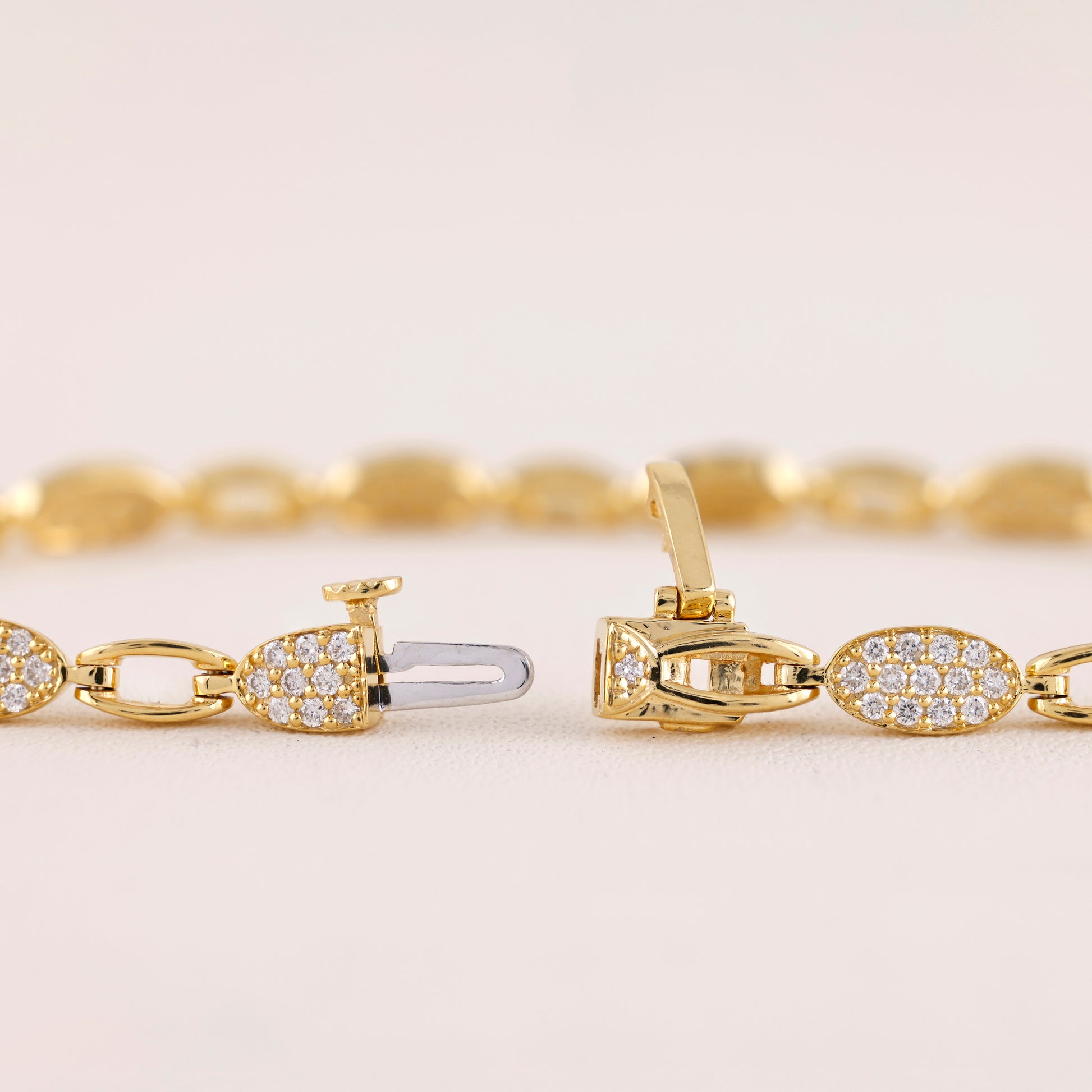 Gold bracelet with diamond accents on a light background