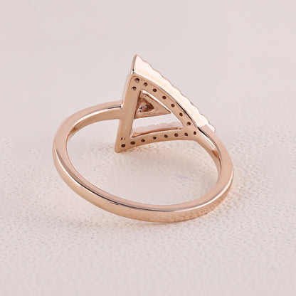 Rose gold ring with a triangular design on a light gray background