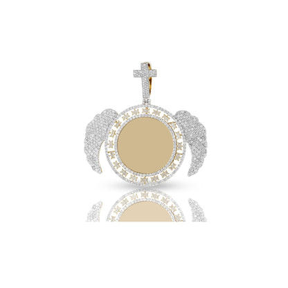 A 14K yellow gold diamond wings picture pendant with round and baguette cut diamonds, featuring a cross and a picture compartment.