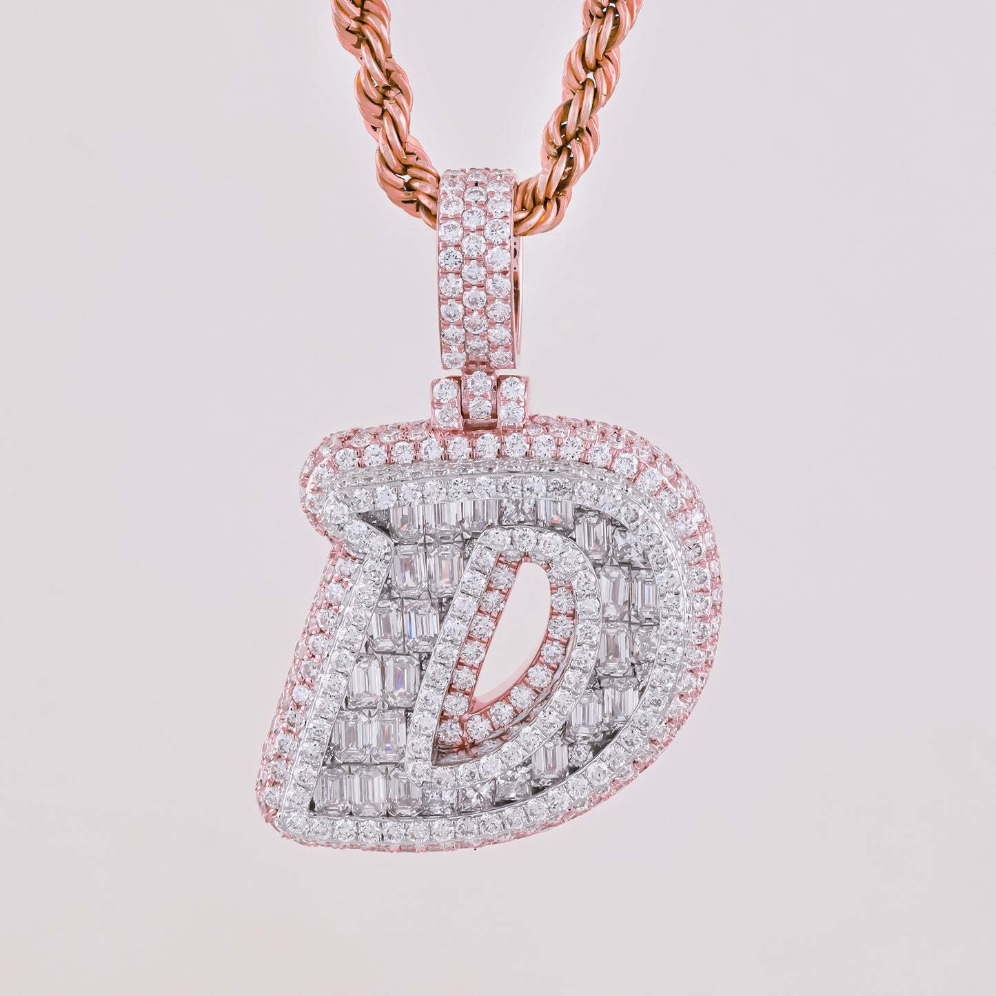 Diamond-encrusted pendant on a pink background