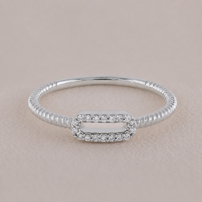 Silver bracelet with a rectangular clasp on a beige background