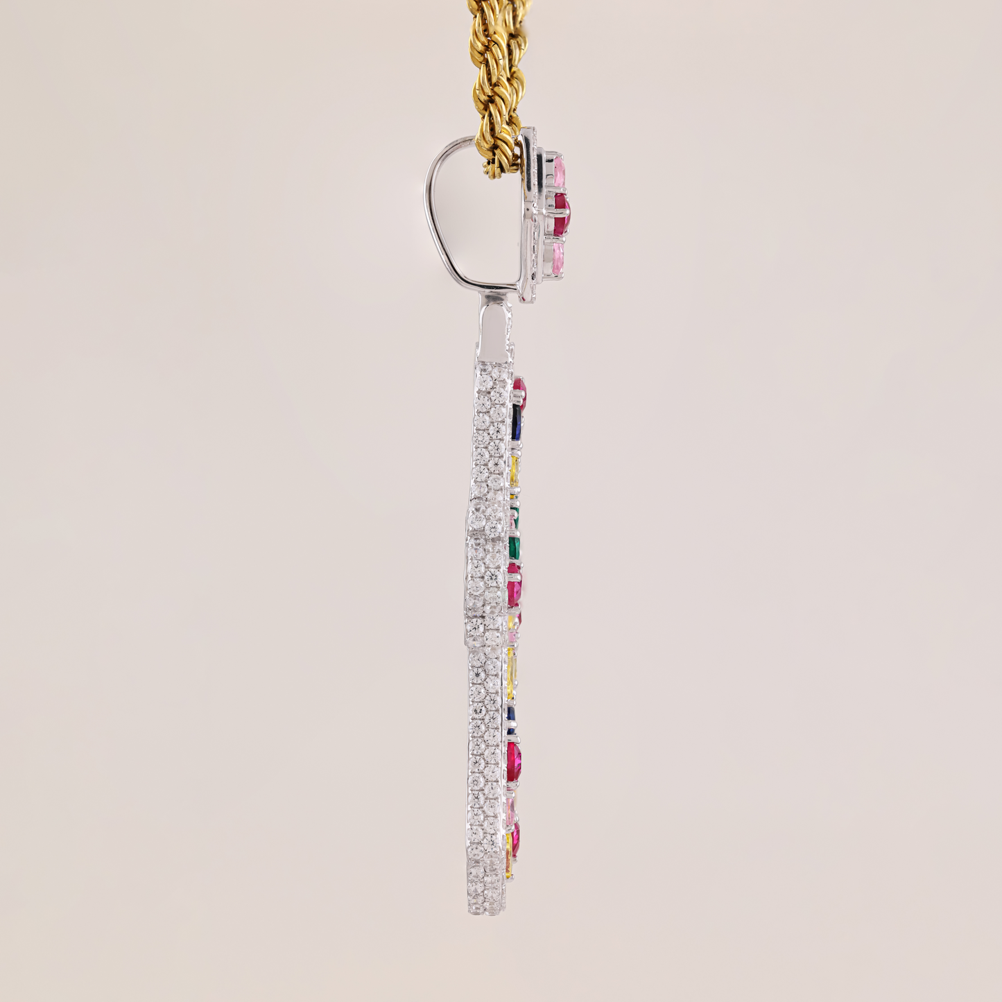 Earring with colorful gemstones on a beige background