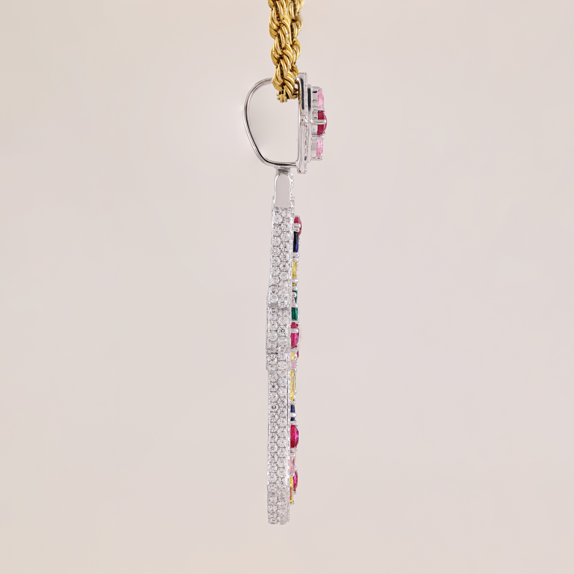 Earring with colorful gemstones on a beige background