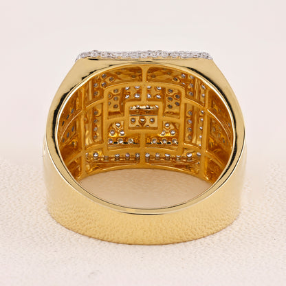 Gold ring with intricate design and small diamonds on a light background