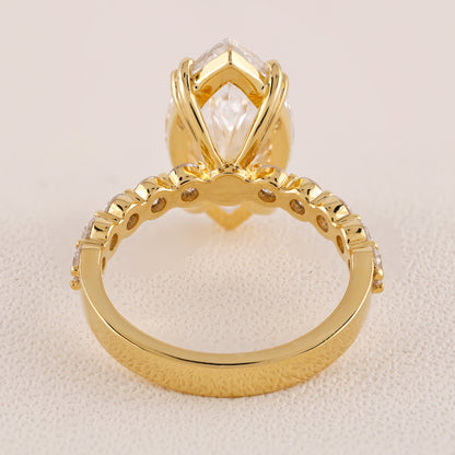 Gold ring with a prominent diamond on a beige background
