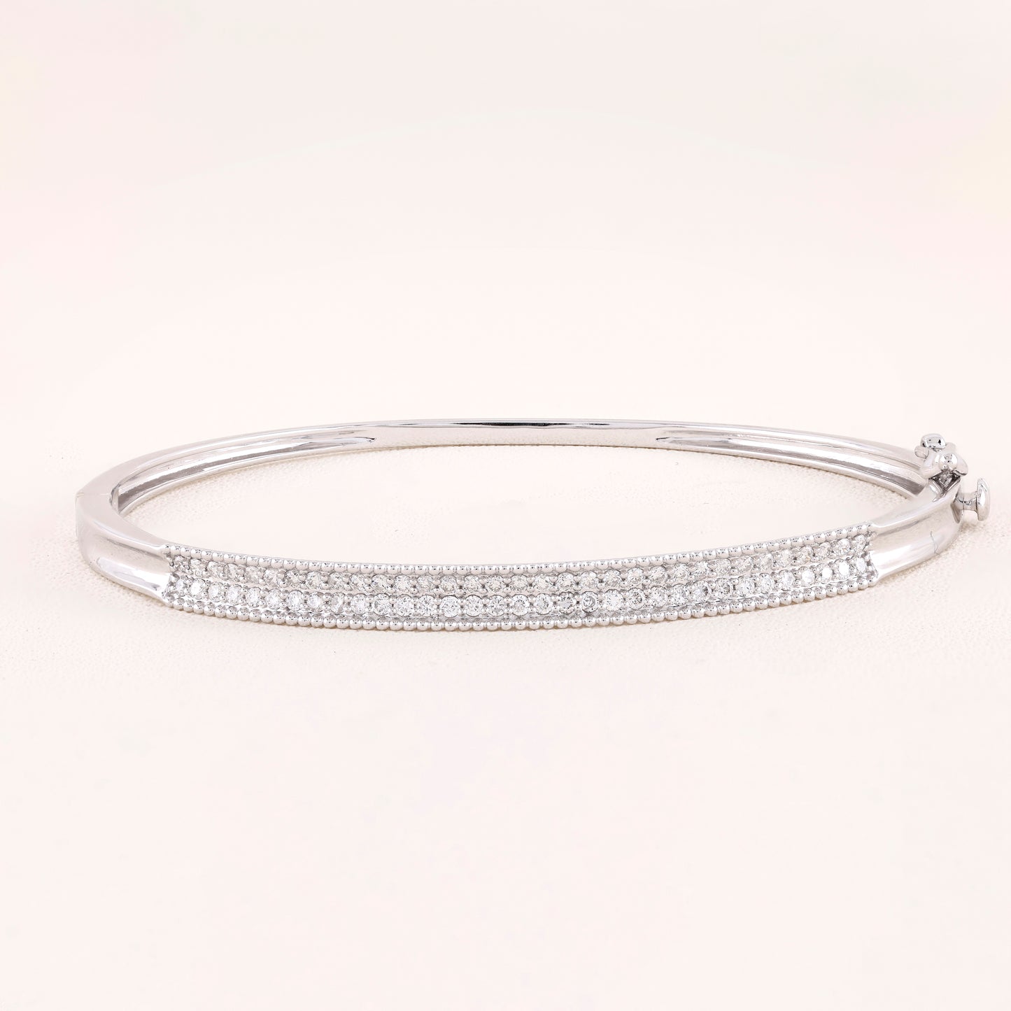 Silver bracelet with clear stones on a white background