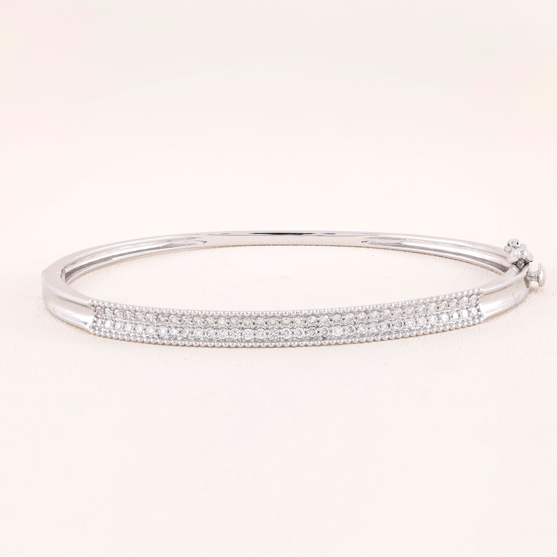 Silver bracelet with clear stones on a white background