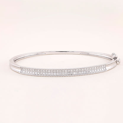 Silver bracelet with clear stones on a white background