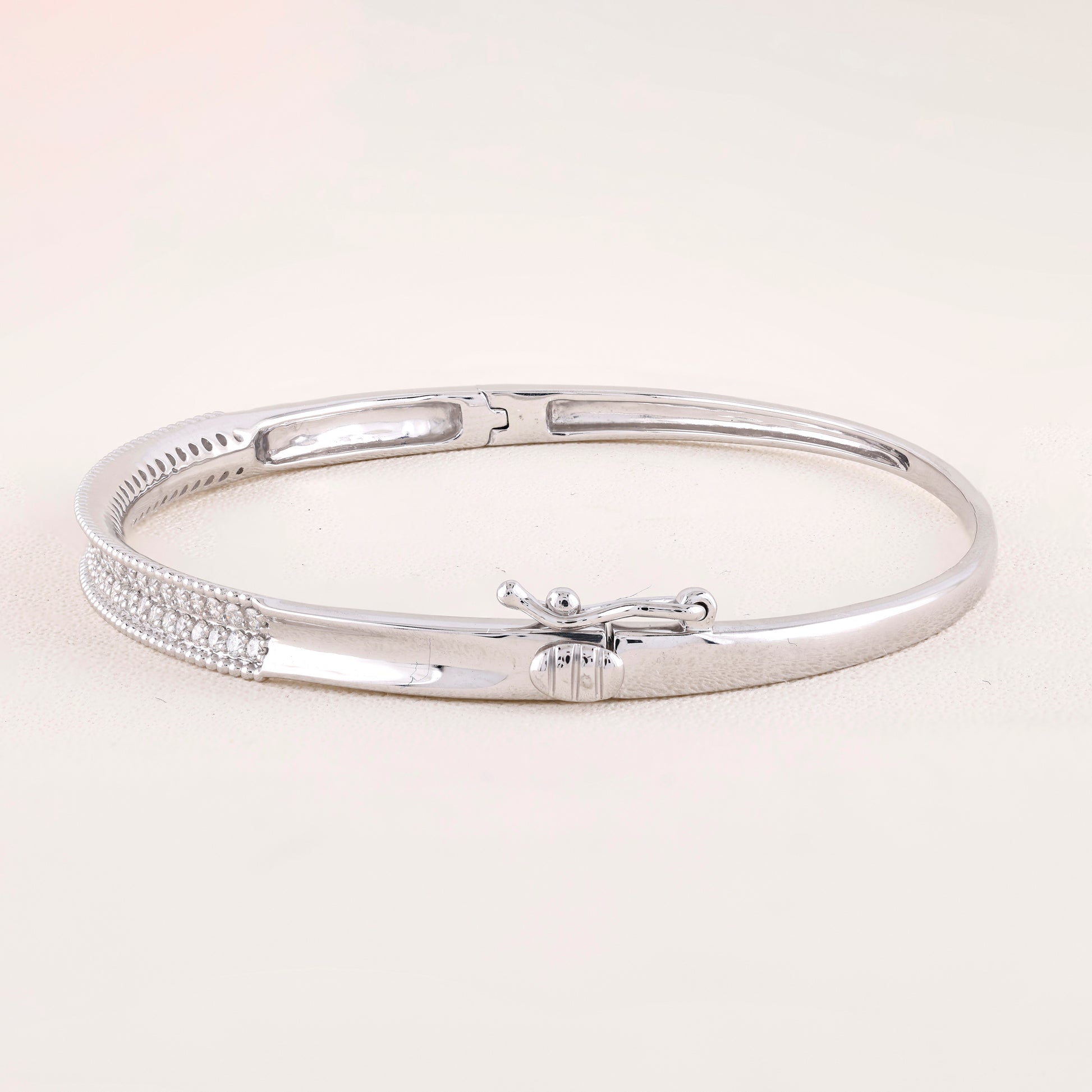 Silver bracelet on a light beige background