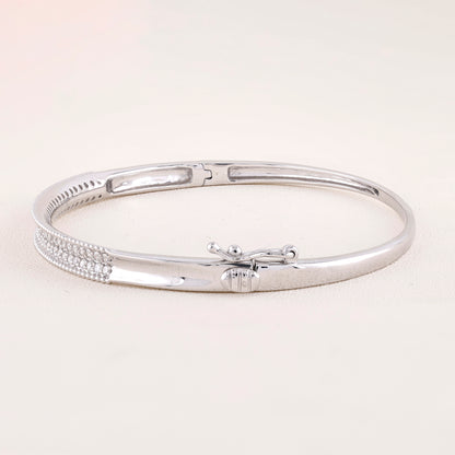 Silver bracelet on a light beige background