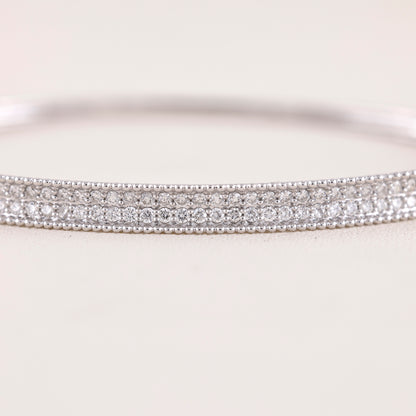 Close-up of a silver bracelet with clear stones on a white background