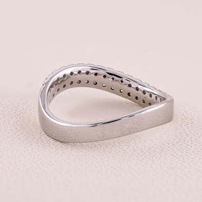 Silver ring with a textured surface on a beige background
