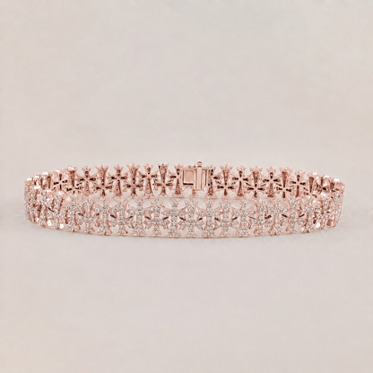 Rose gold bracelet with clear stones on a light gray background