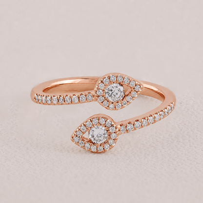 Rose gold ring with diamond accents on a light beige background