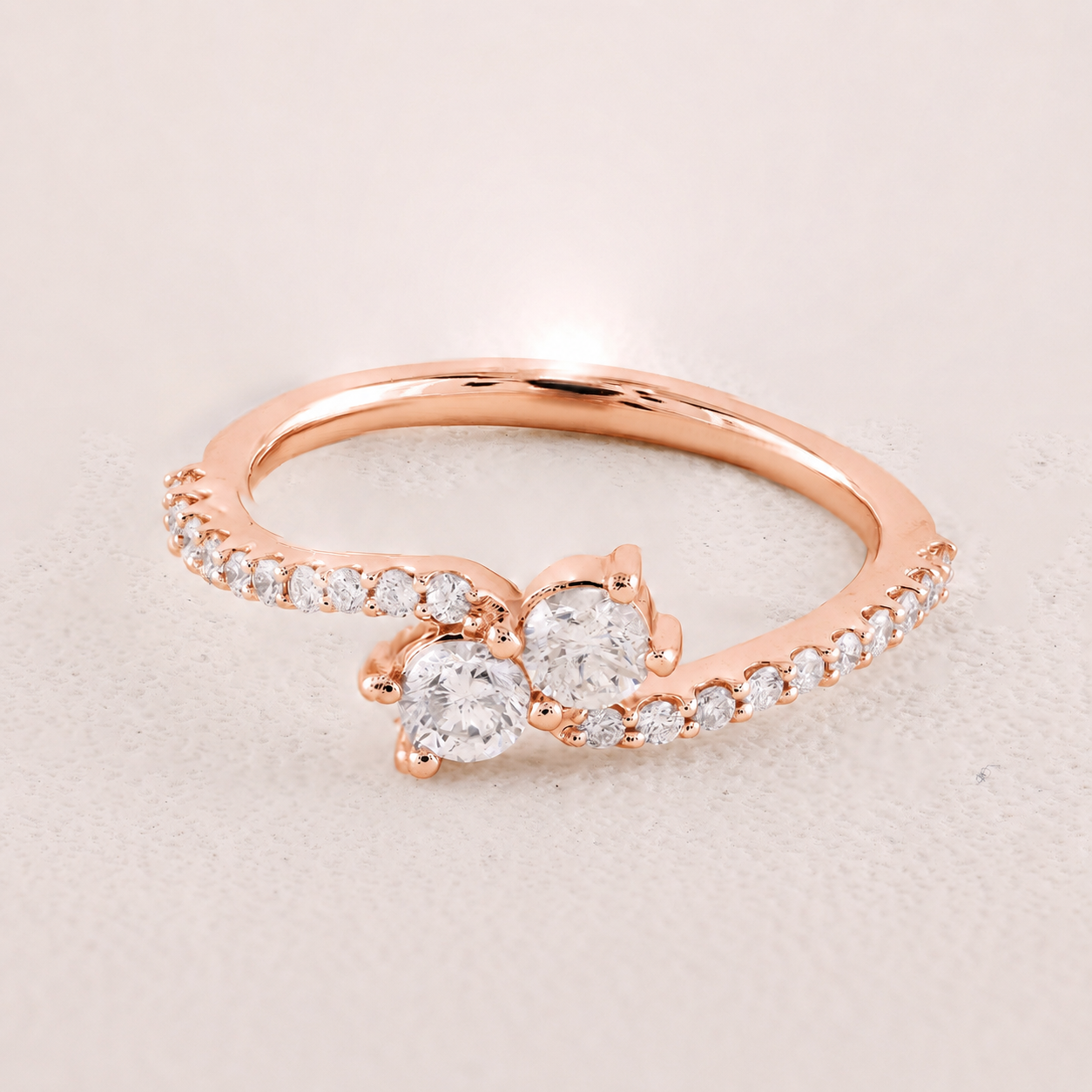 Rose gold bracelet with a star-shaped clasp on a light pink background