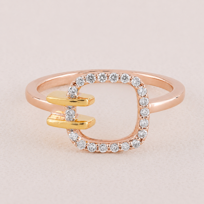 Two-toned ring with rose gold and gold bands and diamond accents on a light background