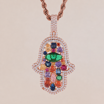 Multicolored gemstone cross pendant on a beige background