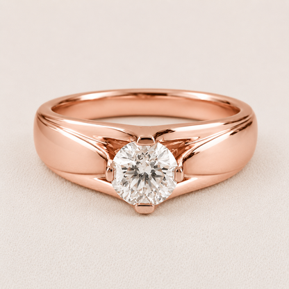 A rose gold solitaire engagement ring with a round brilliant-cut diamond, set on a light beige textured background.