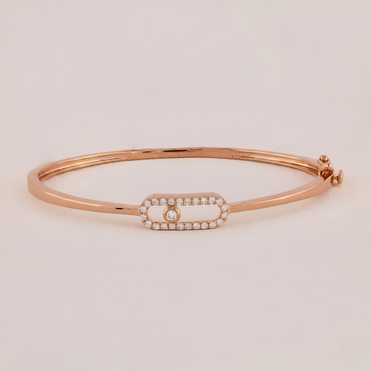 Rose gold bracelet with a diamond on a light beige background