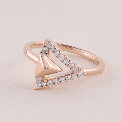 Rose gold ring with diamond accents on a light background