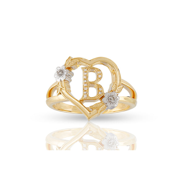 A 10K yellow gold ring featuring a heart shape with an initial letter, surrounded by small diamonds set in a classic six-prong setting.