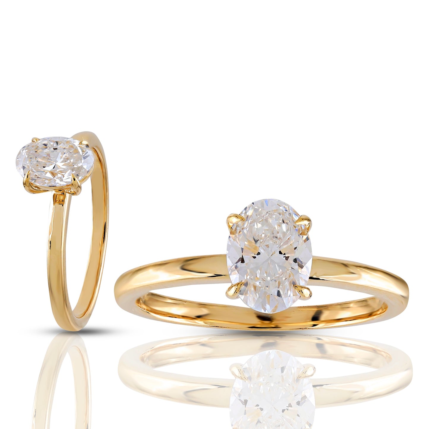Two gold rings with diamond stones on a white background