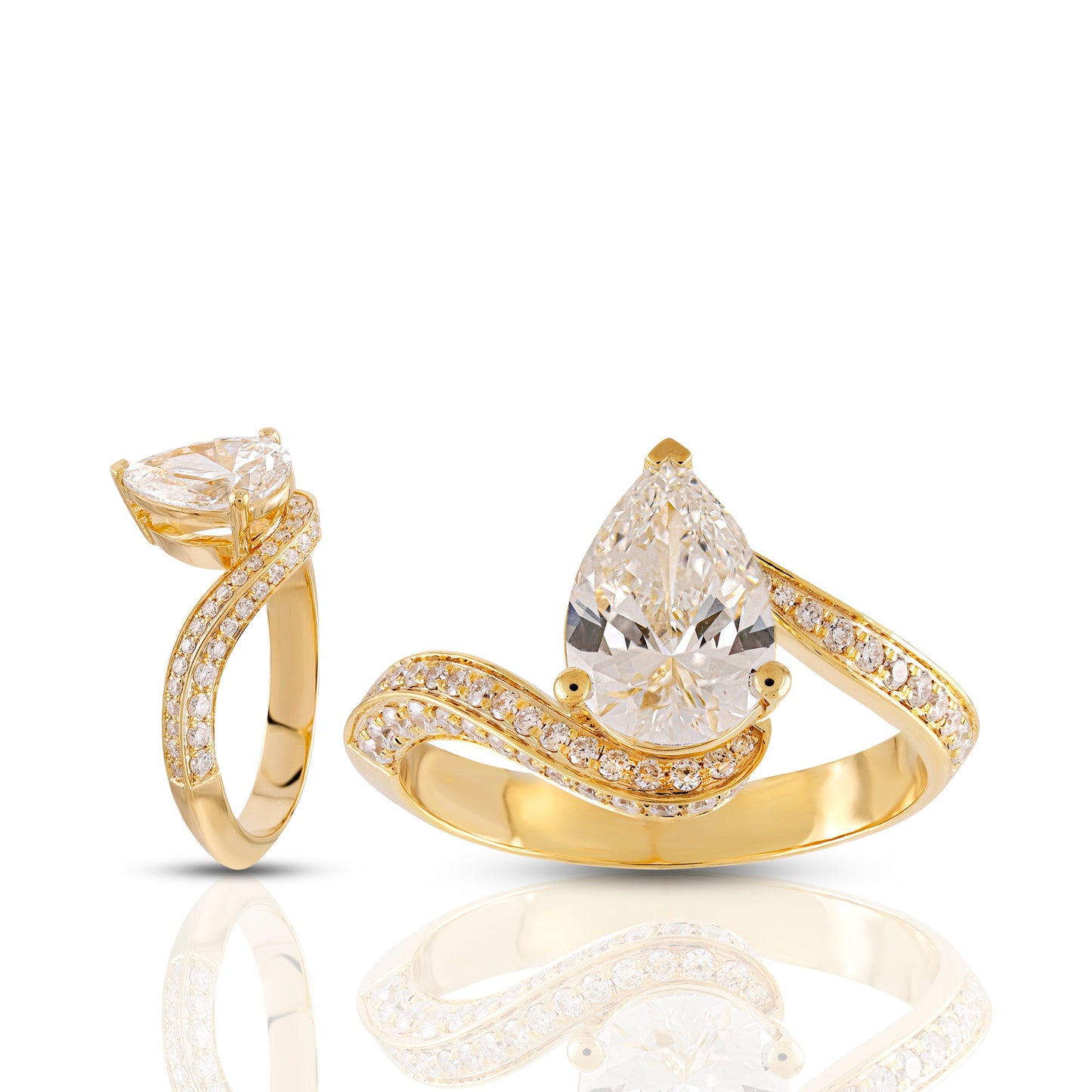 Gold ring with pear-shaped diamond on a white background