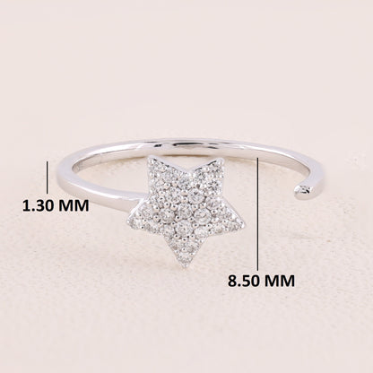 Silver ring with star design and measurements on a beige background