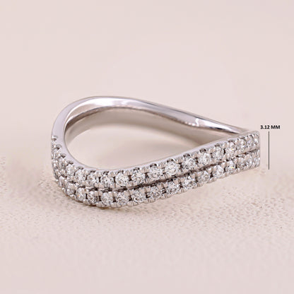 Silver ring with diamond accents on a beige background