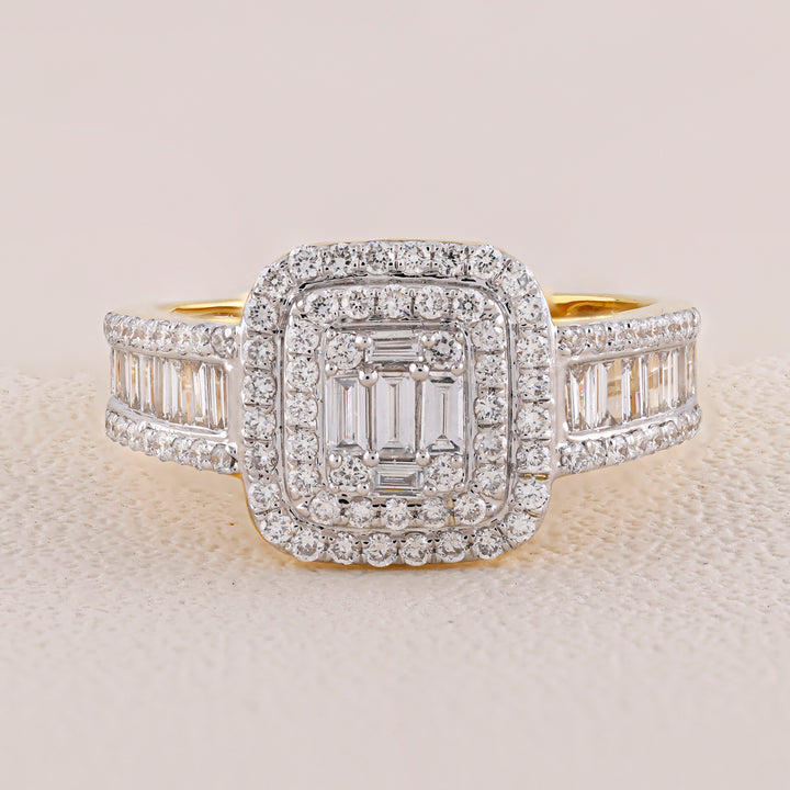 Diamond ring with a central emerald-cut stone and baguette side stones on a light background