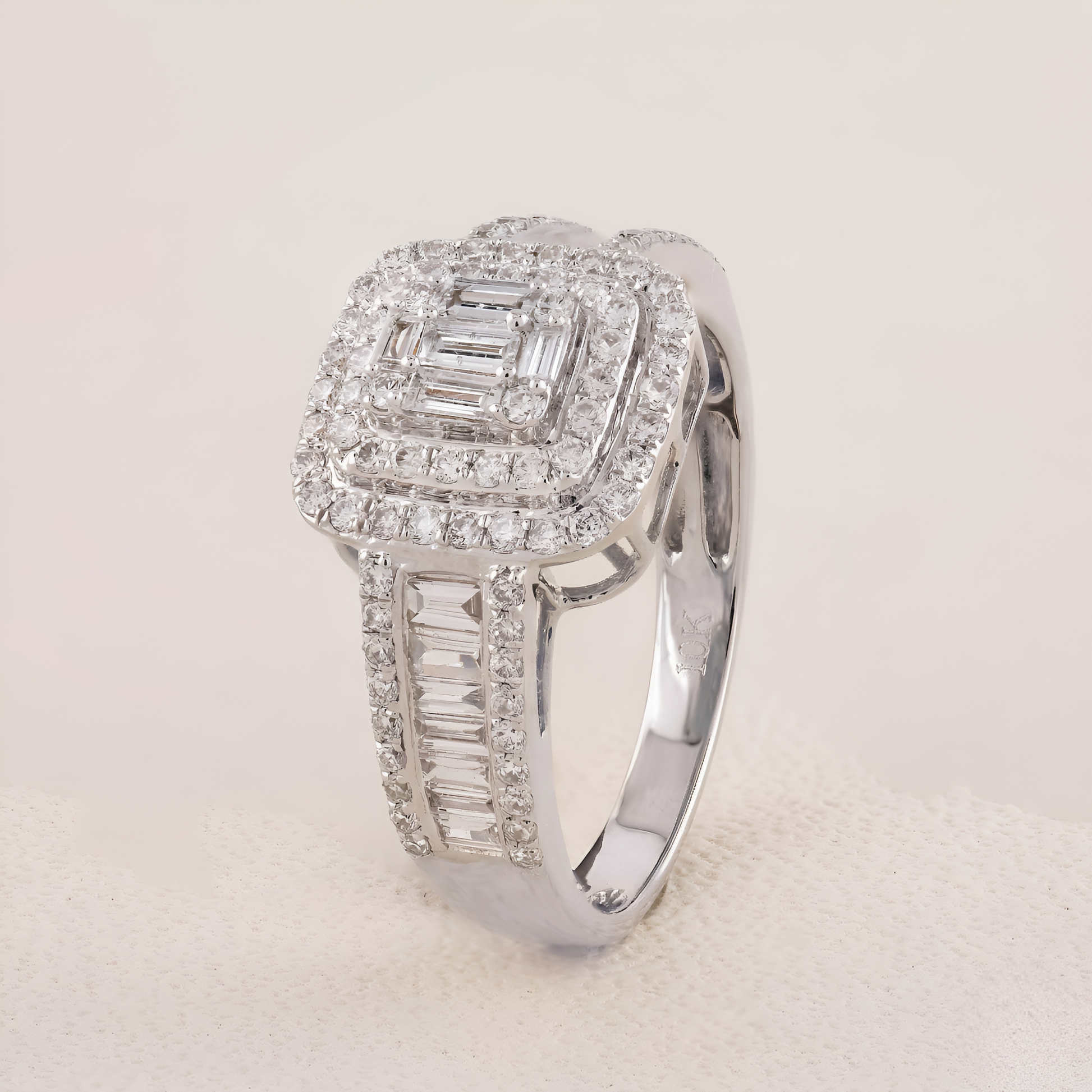 Silver ring with diamond accents on a light gray background