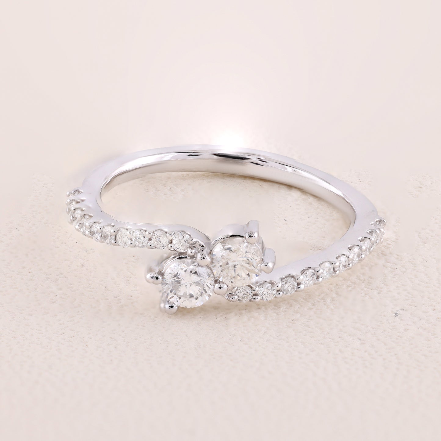 Silver ring with a diamond on a beige background