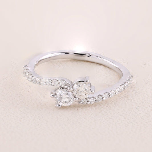 Silver ring with a diamond on a beige background