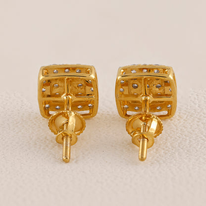 Pair of gold earrings with small diamonds on a beige background
