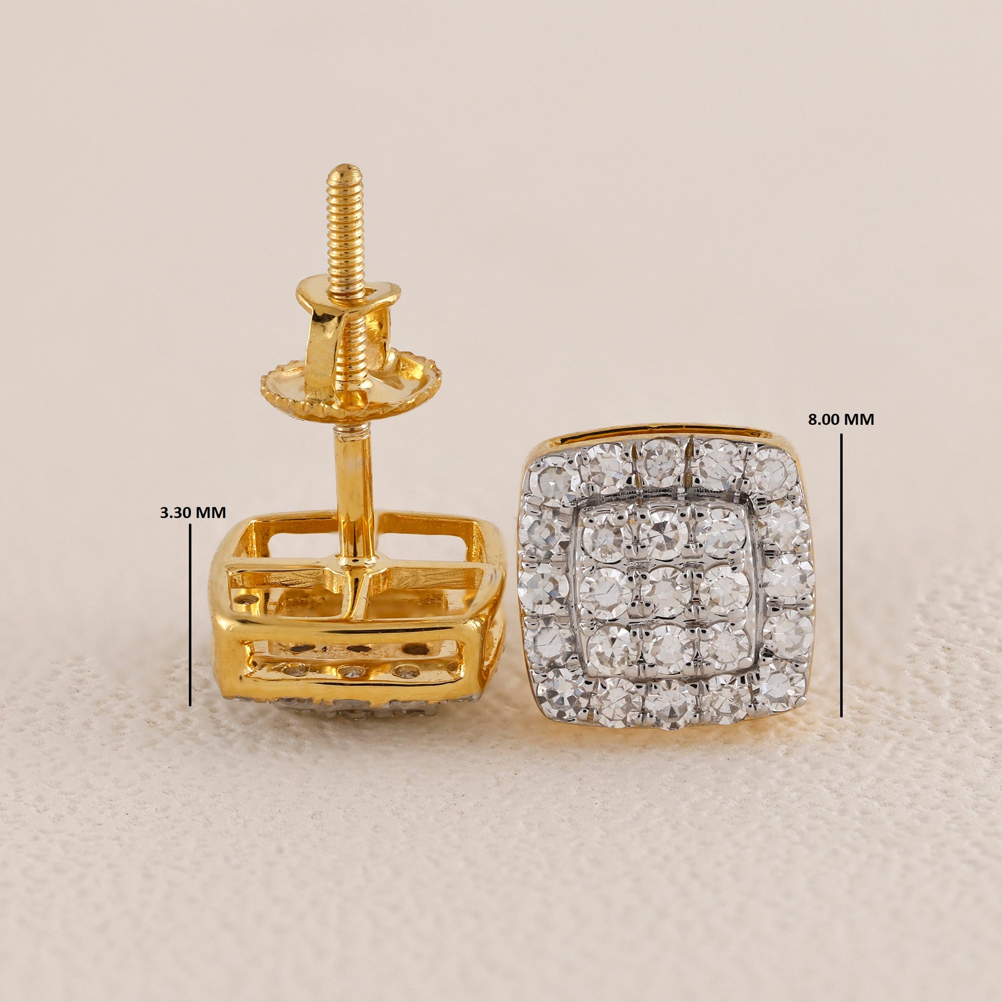 Gold earring with diamond-studded design and measurements on a beige background