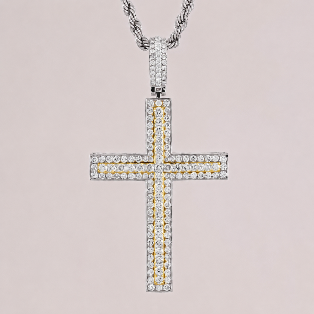 Diamond cross pendant on a chain against a light pink background