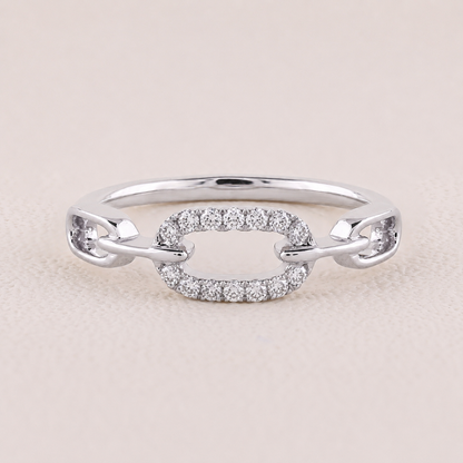 Silver ring with diamond accents on a light beige background