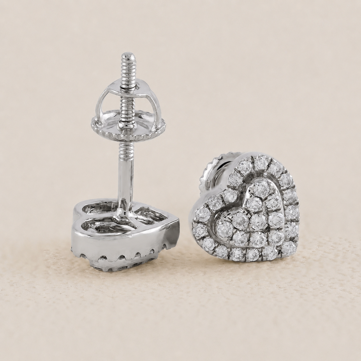 Silver earring with clear gemstones on a beige background