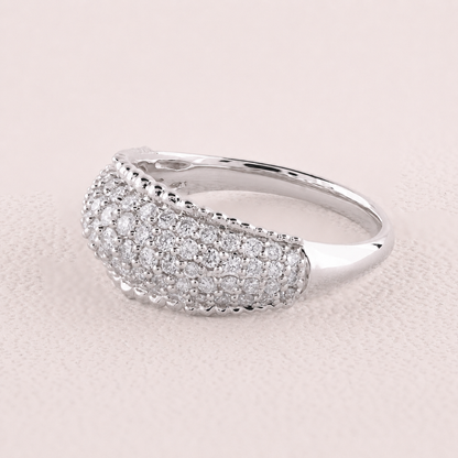 Silver ring with diamond accents on a light pink background