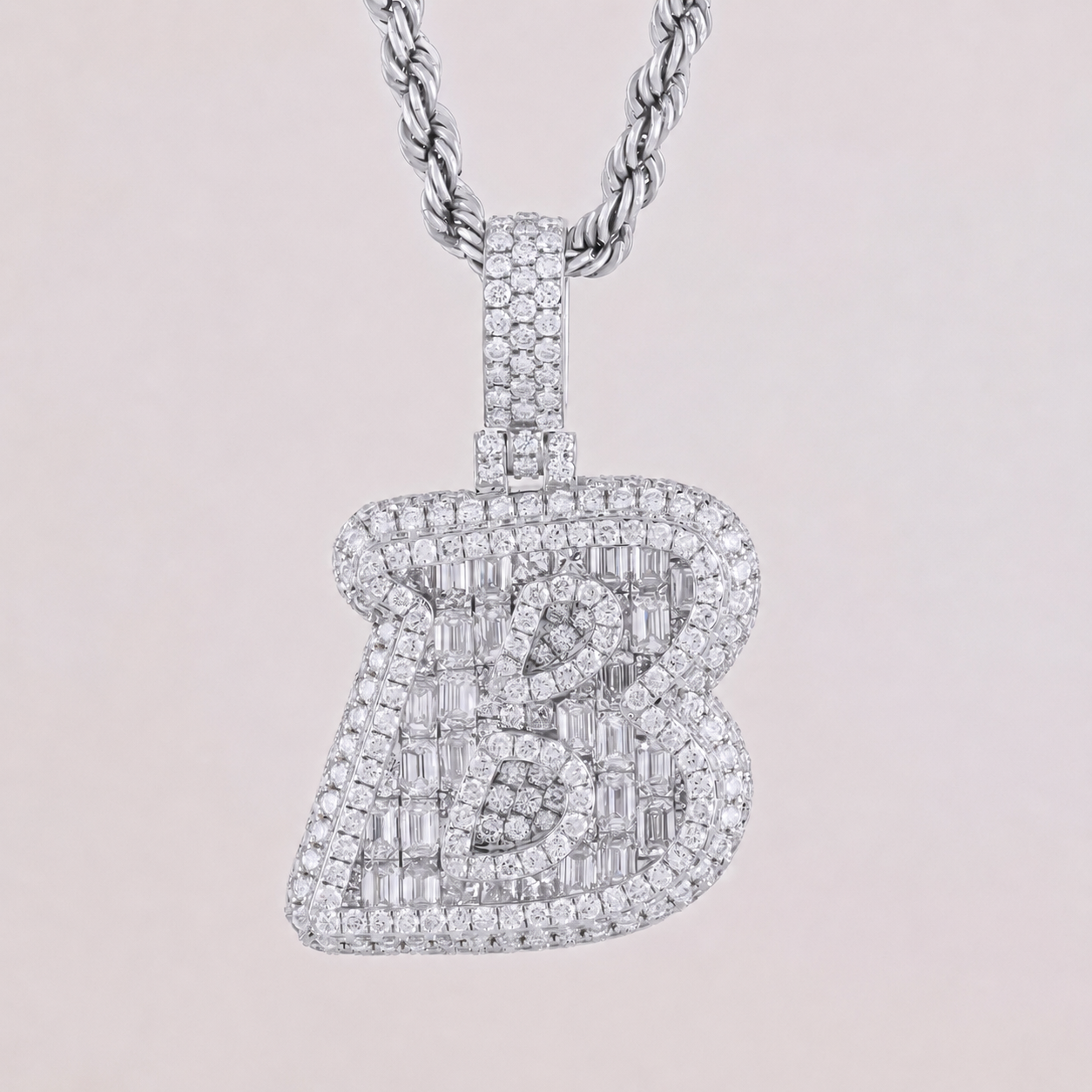 Diamond-studded guitar-shaped pendant on a chain against a light pink background